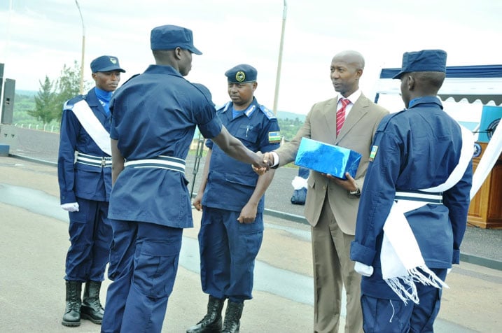 Minisitiri Mussa Fasil Harerimana ahemba umupolisi wahize abandi mu mahugurwa y'amezi 10 yashojwe.