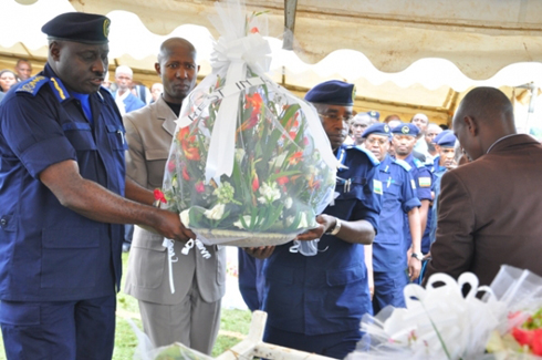 Abayobozi bakuru ba Polisi na Minisitiri w'umutekano bashyira indabo ku mva z'abapolisi baguye mu mpanuka.
