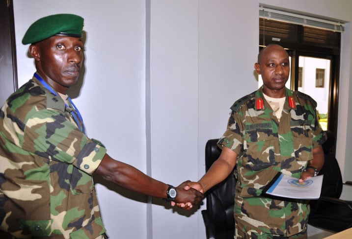 Umuyobozi wa RPA, Col. Rutaremara ashyikirizwa igitabo gikubiyemo inyandiko zivuga ku burenganzira bw'umwana mu bihe byo kubungabunga amahoro.